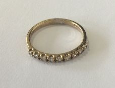 A diamond single row half eternity ring. Approx. 2