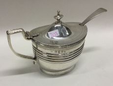 A George III silver mustard pot with bright cut de