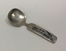 A Persian silver and enamelled caddy spoon depicti