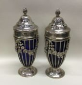 A good pair of silver mounted glass sugar casters.