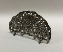 A heavy silver double menu holder with pierced and