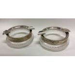 A pair of silver and glass mounted ashtrays. Est.