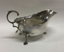 A heavy Edwardian silver sauce boat with card cut
