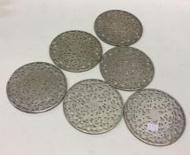 A set of six silver and glass bottle coasters. Ste