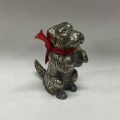 A silver plated figure of a dog. Est. £20 - £30.