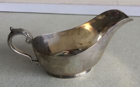 A crested silver boat shaped sauce boat. London 18