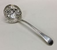 An 18th Century feather edged silver sauce ladle.