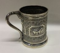 A Victorian silver christening mug chased with don