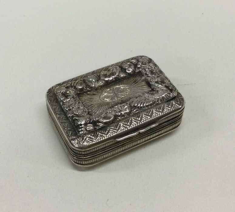 A heavy George III silver vinaigrette embossed wit