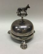 A heavy silver table bell mounted with a cow pushe