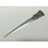 A rare silver letter opener chased with a dragon.