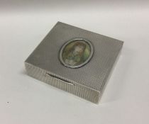 A square silver cigarette box with engine turned d