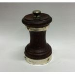 A mahogany and silver mounted pepper grinder of ty