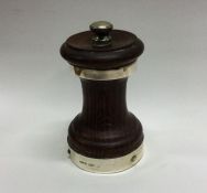 A mahogany and silver mounted pepper grinder of ty