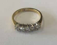 A good diamond five stone ring in 18 carat two col