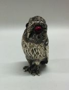 A Victorian silver pepper in the form of an owl. L
