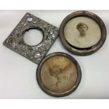 A group of three silver picture frames together wi