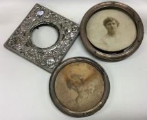 A group of three silver picture frames together wi