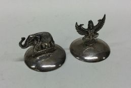 A pair of silver menu holders; one in the form of