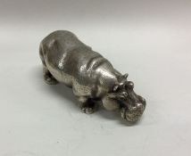 A large and heavy silver figure of a hippopotamus.