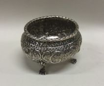 A chased silver bowl on feet. Circa 1920. Approx.