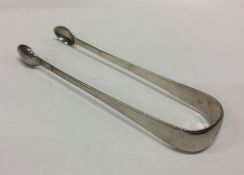 A George III pair of silver ice / sugar tongs with