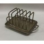 A good heavy Edwardian silver toast rack with gadr