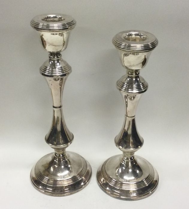 A tapering pair of large silver candlesticks with - Image 2 of 2