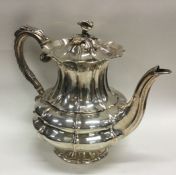 A heavy George III silver teapot with chased flora