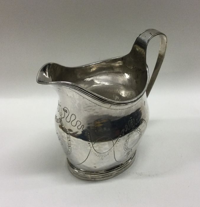 A good Georgian bright cut silver cream jug. Londo - Image 2 of 2