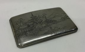A Japanese silver engraved cigarette case depictin