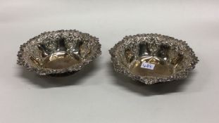 A pair of silver bonbon dishes of circular form. A