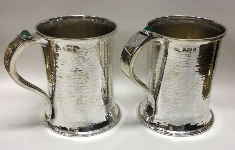 A fine pair of Arts & Crafts silver pint mugs with