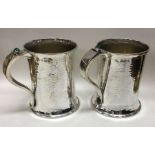 A fine pair of Arts & Crafts silver pint mugs with