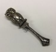 A silver rattle in the form of an owl. Marked to h