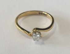 A good diamond single stone cross over ring in 18