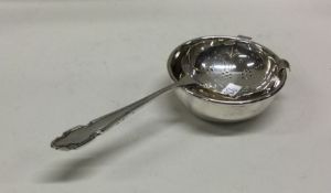 A silver tea strainer on stand. Sheffield 1964. By