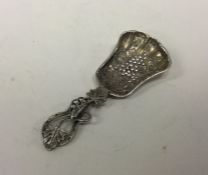 A cast silver caddy spoon mounted with grapes. Bir