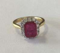 An attractive ruby and diamond cluster ring with c