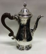 A George III silver crested baluster shaped coffee