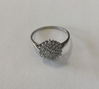 A small diamond circular cluster ring in 9 carat w