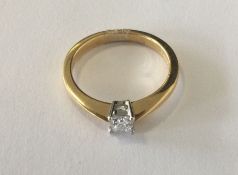 A small princess cut diamond single stone ring in