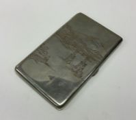 A Japanese silver cigarette case engraved with ani