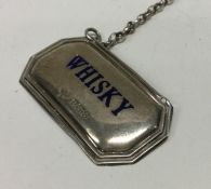 A rare silver and enamel wine label for ‘Whisky’.