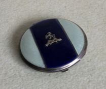A silver and enamelled compact with engine turned