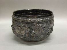 An Indian silver bowl decorated with figures. Appr