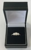 A good quality diamond three stone cluster ring in