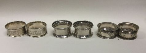 Three good pairs of silver napkin rings decorated