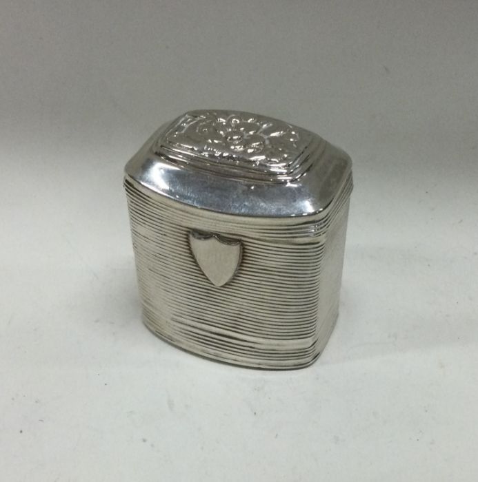 A Continental hinged silver box with chased flower