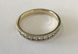 A good diamond half eternity ring in gold setting.